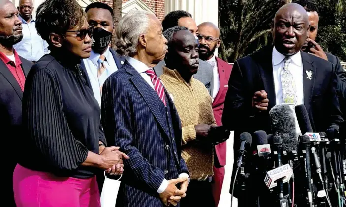  ?? Photograph: Lewis M Levine/AP ?? Aattorney Benjamin Crump, right, speaks as Marcus Arbery, second from right, his former wife Wanda Cooper, left, and the Rev Al Sharpton listen outside the Glynn county courthouse on Wednesday, in Brunswick, Georgia.