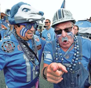  ?? TOM HAWLEY/THE MONROE NEWS
PROVIDED BY THE DETROIT RIVERFRONT CONSERVANC­Y ?? Detroit Lions fans Robert Gonzales and Ron Crachiola roar outside the Eastern Market in Detroit before the Lions game on Oct. 7, 2018. This weekend, sports bars are set to screen the playoff game between the Lions and the Tampa Bay Buccaneers.