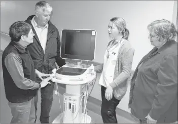  ?? SUBMITTED PHOTO ?? Western Hospital nurse Justina Gaudet explains the functions of a point-of-care ultrasound unit to Western Hospital Foundation members Krystyna Pottier, left, Dave McKenna and Marlene Bolger. The foundation contribute­d funds towards the purchase of the mobile unit.