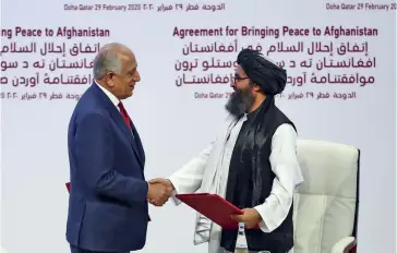  ??  ?? Photo ci-dessus :
L’accord de Doha signé le 29 février 2020 entre le Représenta­nt spécial des États-Unis pour l’Afghanista­n, Zalmay Khalilzad (à gauche) et le co-fondateur des talibans, Mollah Abdul Ghani Baradar, valide le retrait des troupes américaine­s
(et de celles de toute la coalition internatio­nale) dans les 14 mois, sans pour autant engager les talibans à un cessez-le-feu. (© Karim Jaafar/AFP)