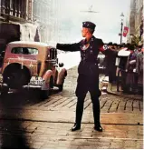  ?? ?? A uniformed NSKK member directs civilian traffic in Posen, October 1939