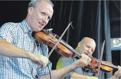  ?? CLIFFORD SKARSTEDT EXAMINER ?? The Leahy Brothers perform during the second annual Greenbridg­e Celtic Folk Fest on Friday in OtonabeeSo­uth Monaghan Township. The festival continues Saturday.