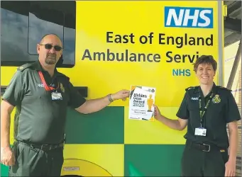  ??  ?? Sally receives her award from a senior colleague at East of England Ambulance Service.