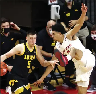  ?? NOAH K. MURRAY — THE ASSOCIATED PRESS ?? Rutgers guard Geo Baker (0) defends against Iowa guard CJ Fredrick (5) during Saturday’s game in Piscataway.