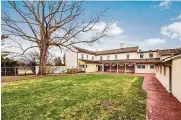  ?? ?? The rear has a partially covered patio and brick pavers that create walkways throughout the property. There is a partially fenced yard.