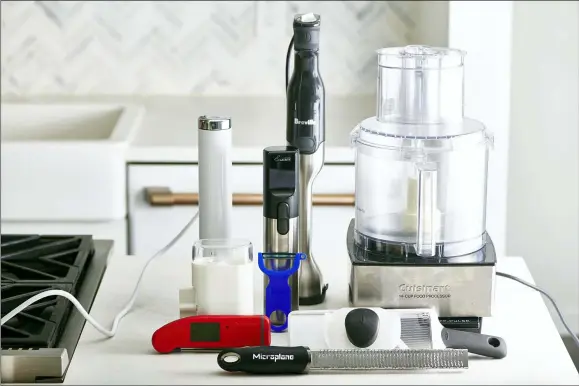  ?? CHEYENNE COHEN — KATIE WORKMAN VIA AP ?? This December 2019photo shows an assortment of various kitchen gadgets in New York, including a food processor, back right.