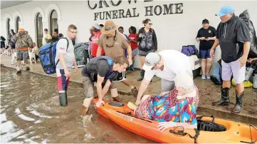  ??  ?? People wait to be evacuated from flood waters from Hurricane Harvey in Dickinson,Texas. — Reuters photo