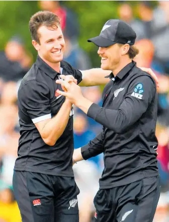  ?? Photo / Photosport ?? Adam Milne (left), celebratin­g a wicket against India with Finn Allen at Hagley Oval, looms as a World Cup weapon.