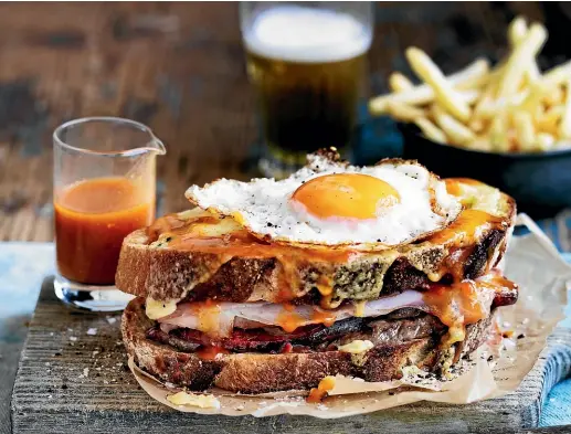  ?? PHOTOS: WILLIAM MEPPEM/ NINE ?? Portugal’s Francesinh­a sandwich is a meat-stuffed tower covered in melted cheese and a tomato and beer-based sauce.