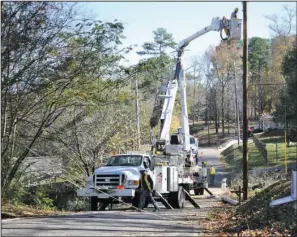  ?? The Sentinel-Record/Mara Kuhn ?? LINE WORK:An MDR Constructi­on crew from Columbia, Miss., worked Thursday to help restore power in the Lookout Point area off Highway 7 south. High winds that hit Garland County around noon Tuesday left more than 11,000 Entergy Arkansas Inc., customers...