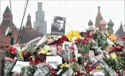  ?? PICTURE: AP ?? FLORAL TRIBUTES: Flowers and pesters reading “Propaganda kills, fight!” at the place where Boris Nemtsov, a charismati­c Russian opposition leader and sharp critic of President Vladimir Putin, was gunned down on Friday night near the Kremlin.