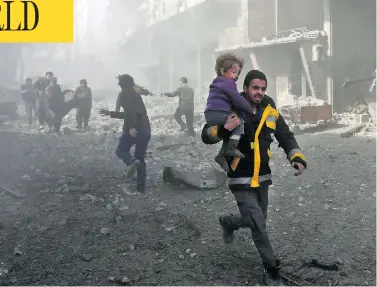  ?? ABDULMONAM EASSA / AFP / GETTY IMAGES ?? A man rescues an infant after a bombing raid on the outskirts of the Syrian capital Damascus on Sunday. At least 71 people were killed and more than 300 were injured in 24 hours of intense bombing in eastern Ghouta, observers said.