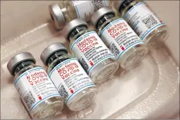  ?? ANTONIO PEREZ/CHICAGO TRIBUNE ?? Empty bottles of Moderna COVID-19 vaccines sit in a tray after having been used to inoculate people at Will County Community Health on Monday in Joliet.