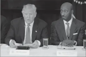  ?? TRIBUNE NEWS SERVICES FILE PHOTO ?? Kenneth Frazier, right, CEO of Merck, resigned from President Donald Trump’s Manufactur­ing Council, in the wake of the president’s reaction to the violence in Virginia.