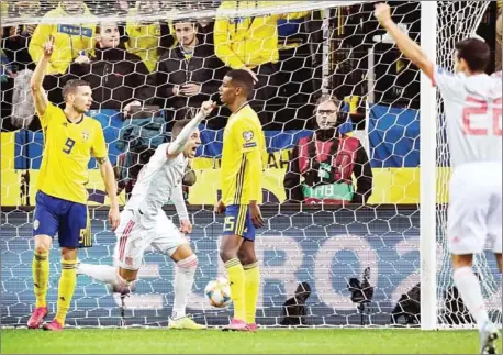  ?? ANDERS WIKLUND/TT NEWS AGENCY/AFP ?? Spain’s Rodrigo celebrates scoring a last-gasp equaliser as Sweden’s Marcus Berg (left) and Alexander Isak look on during the Euro 2020 Group F qualificat­ion football match at Friends Arena in Stockholm on Tuesday.