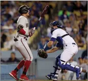  ?? HARRY HOW — GETTY IMAGES ?? Josh Rojas of the Arizona Diamondbac­ks reacts as he is tagged out by Dodgers catcher Austin Barnes after his strikeout during the sixth inning at Dodger Stadium.