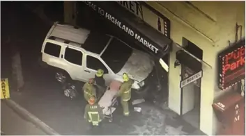  ?? FOX 11 KTTV VIA AP ?? This aerial screenshot released by FOX 11 KTTV shows Los Angeles firemen at the scene of a vehicle crash on West Hollywood Boulevard in the Hollywood district of Los Angeles, Friday.