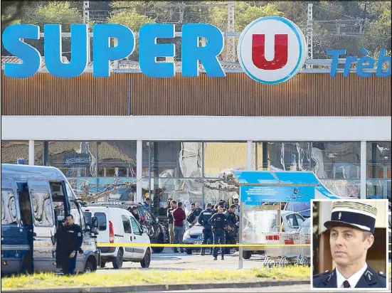  ?? REUTERS ?? Photo shows gendarmes and police officers at a supermarke­t in Trèbes, France after a hostage drama on Friday. Inset photo shows French Lt. Col. Arnaud Beltrame.