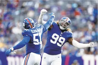  ?? ADAM HUNGER/AP PHOTOS ?? New York Giants outside linebacker Azeez Ojulari and defensive end Leonard Williams celebrate during Sunday’s game against the Carolina Panthers in East Rutherford, New Jersey.
UP NEXT
N.Y. Giants (2-5) at K.C. Chiefs (3-4) at Arrowhead Stadium 8:15 p.m. Nov. 1 (ESPN)