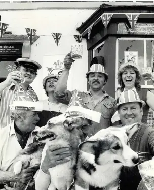  ?? Barbara Dunham ?? Corgis give a royal touch to the wedding celebratio­ns at the Prince of Wales pub in Stourbridg­e Road, Hagley. Sitting at the front are licensee Ron Higgs, his wife, Vi, and Graham Jones, and behind are pub regulars Steve Johnson, Maria Jones, and Ian and