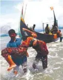  ??  ?? An exhausted Rohingya woman is carried to shore in Shah Porir Dwip, Bangladesh.