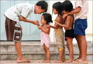  ?? PHILIPPE LOPEZ/AFP ?? Cambodian orphans play together as they wait for adoption at Kien Klaing orphanage centre in Phnom Penh. A new study has found that as many as one in 100 Cambodian children live in residentia­l care institutio­ns.