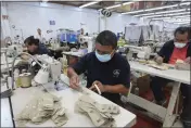  ?? MARIO ARMAS — THE ASSOCIATED PRESS ?? A man works in a shoe maquilador­a or factory in Leon, Mexico, on Feb. 7.