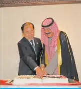  ??  ?? KUWAIT: Japanese Ambassador to Kuwait Takashi Ashiki (left) and Kuwait’s Deputy Foreign Minister Khaled AlJarallah cut the cake during the reception. — Photos by Joseph Shagra