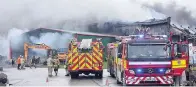  ??  ?? > Fire crews deal with the blaze at SiteServ Recycling