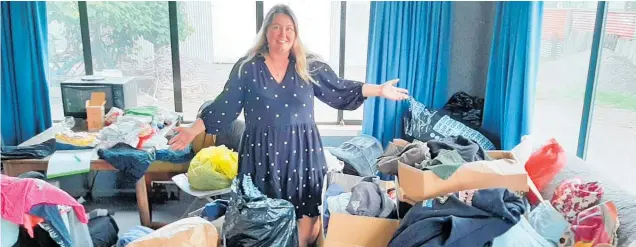  ?? ?? Nicola Freyer with bags and boxes of donated clothing, ready to be sorted.