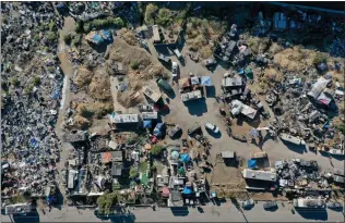  ?? JANE TYSKA — STAFF PHOTOGRAPH­ER ?? The Wood Street homeless encampment is seen from a drone view in Oakland on July 14, 2022. A week after a federal judge gave Oakland the go-ahead to clear one of its most prominent homeless encampment­s, he reversed his decision Friday, allowing unhoused people to remain there until the city opens more shelter beds.