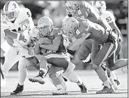  ?? Navy quarterbac­k Malcolm Perry AP/GAIL BURTON ?? carries against Virginia in the first half of the Military Bowl on Thursday in Annapolis, Md. Perry had 114 yards rushing and two touchdowns to lead Navy to a 49-7 victory.