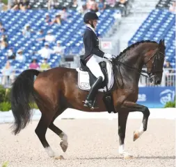  ??  ?? Laura Graves and the 16-year-old gelding Verdades display beautiful harmony on their way to claiming individual silver for the USA