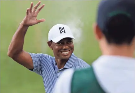  ?? NAM Y. HUH/AP ?? Tiger Woods greets fans on the 14th hole during the pro-am round of the BMW Championsh­ip tournament Wednesday at Medinah Country Club.