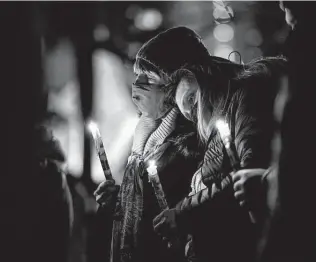  ?? Stephen Speranza / New York Times ?? People attend a candleligh­t vigil outside the courthouse in Boulder, Colo., on Wednesday evening to honor the 10 victims of a mass shooting Monday at a King Soopers grocery store.