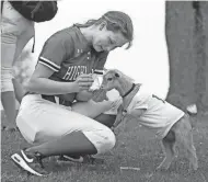  ?? ?? Roo climbs up on Maddy Huml for a postgame snack.