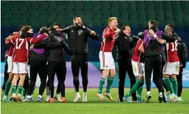  ?? ?? Hungary celebrate qualificat­ion after a 2-2 draw behind closed doors in Sofia. Photograph: Nikolay Doychinov/AFP/Getty Images