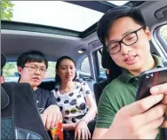  ?? PROVIDED TO CHINA DAILY ?? A Didi Chuxing driver confirms the GPS route with passengers in his car.