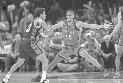  ?? NATHAN J FISH/THE OKLAHOMAN ?? Oklahoma City Thunder forward Darius Bazley (55) guards San Antonio Spurs forward Zach Collins (23) in the first quarter during a game between the Oklahoma City Thunder and the San Antonio Spurs at Paycom Center in Oklahoma City on Dec. 27.