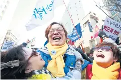  ??  ?? South Koreans cheer after the court’s ruling on the impeachmen­t of South Korean President Park Geun-hye near the Constituti­onal Court in Seoul yesterday.