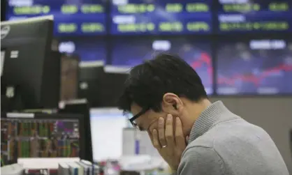  ??  ?? Asian stock markets have plummeted again and the FTSE 100 index fell by almost 8%. Photograph: Ahn Young-joon/AP