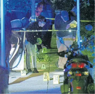  ?? HERALD PHOTO BY JIM MICHAUD ?? GUNNED DOWN: Cops work at the scene of a fatal shooting Monday night in Dorchester.