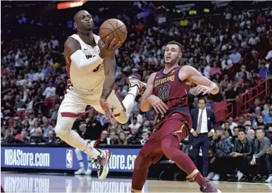  ?? MICHAEL LAUGHLIN/STAFF PHOTOGRAPH­ER ?? Miami Heat guard Dwyane Wade is fouled by the Cleveland Cavaliers’ Larry Nance Jr. during the first half of Tuesday’s game.