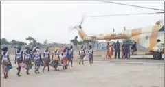  ?? RED CROSS/AFP ?? Some of the 82 rescued Chibok girls head towards a Nigerian Army helicopter yesterday in Borno state, Nigeria.