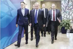  ??  ?? JERUSALEM: Israeli Prime Minister Benjamin Netanyahu (center) arrives for a weekly cabinet meeting yesterday. — AP