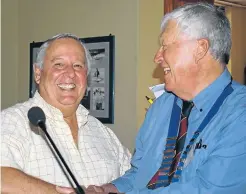  ?? Picture: ROB KNOWLES ?? DE POWER OF BEER: Former SAB brewer, Ray de Power, left, spoke of his life as an ex-pat at the Kowie Probus Club meeting, held at the Ski-boat Club on Tuesday. Probus president Doug Sutherland gave him a hearty handshake after his talk