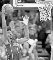  ?? JOHN RAOUX/ASSOCIATED PRESS ?? Jonathan Isaac grabs a rebound Friday. His defense has outshined his offense since he returned from injury.