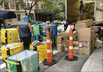  ?? (AP) ?? An Amazon truck is unloaded for deliveries on New York’s Upper West Side in August.