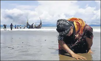  ?? REUTERS ?? A Rohingya refugee touches the shore after crossing the Bangladesh­myanmar border by boat.