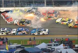 ?? Brian Lawdermilk Getty Images ?? SEVERAL CARS GET CAUGHT in a crash during NASCAR’s Daytona 500. The fiery pileup knocked out 21 cars and led to one of the race’s two red flags Sunday.